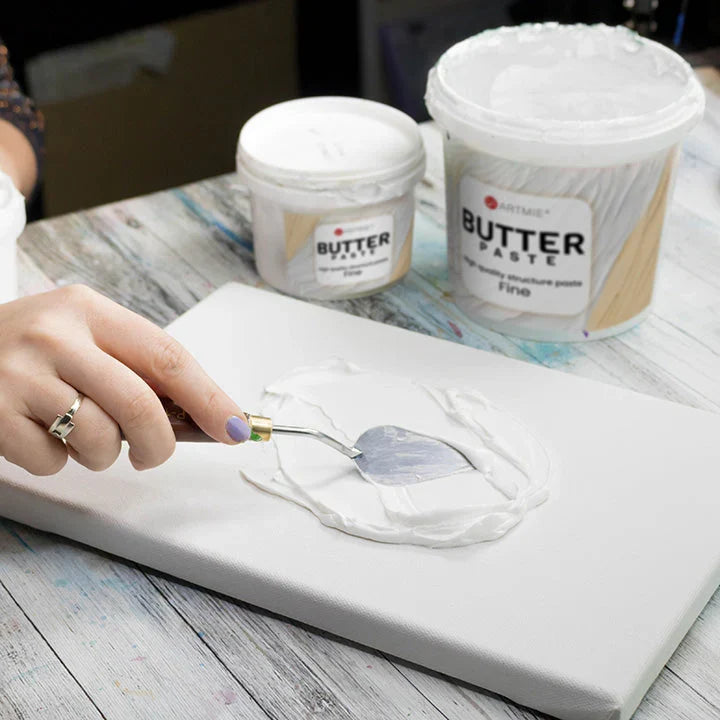 Applying ARTMiE Butter Fine relief paste to a canvas panel