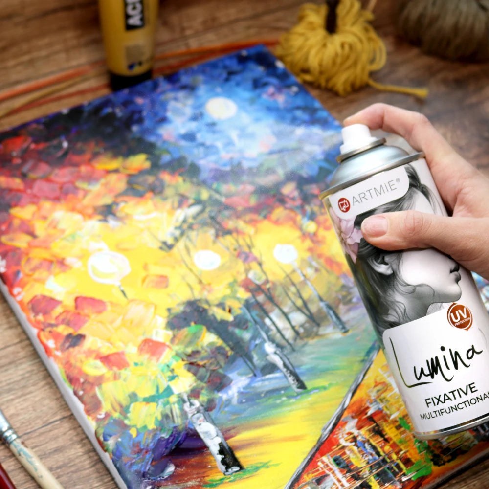 Applying ARTMiE Lumina fixative to an acrylic painting in a studio