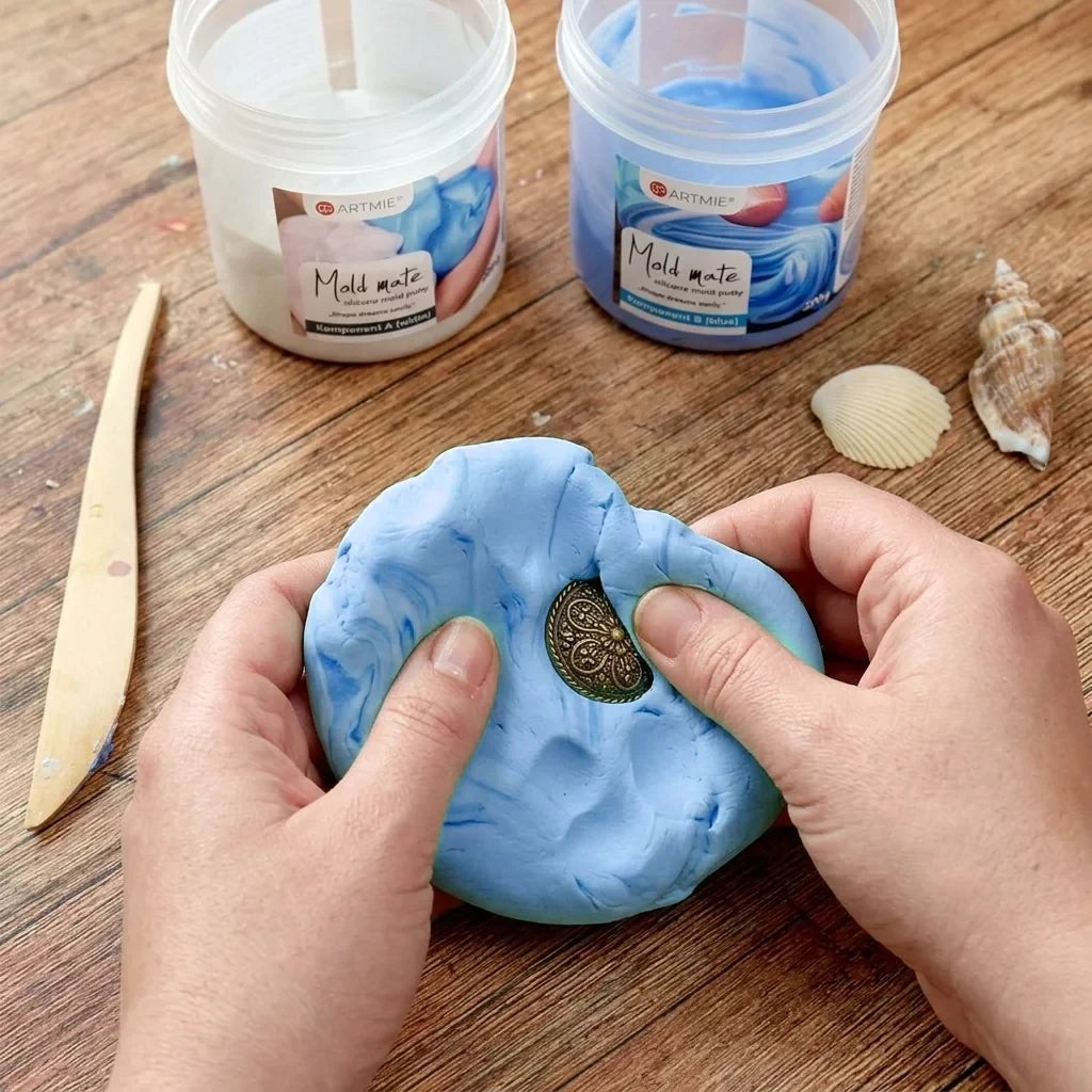 Imprinting a medallion into mixed ARTMiE Mold Mate silicone compound on a worktable